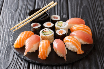 Wall Mural - Japanese sushi on a rustic dark background. Sushi rolls, nigiri, maki, soy sauce. Sushi set on a table. background. Asian food. Horizontal