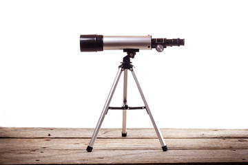 Wall Mural - telescope on a white background laid on wooden board