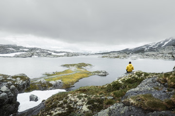 Wall Mural - Typical norwegian landscape with snowy mountains and clear lake near the Trolltunga rock - most spectacular and famous scenic cliff in Norway