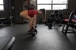 © Wavebreak Media - Woman lifting barbell in fitness studio