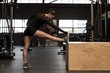 © Wavebreak Media - Young woman stretching in gym