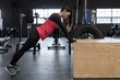 © Wavebreak Media - Woman doing push up exercise in fitness studio