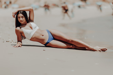 Wall Mural - Young beauty latin woman lying on the sand the ocean coast