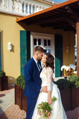 Beautiful Bride and Groom enjoy each other. happy romantic young couple celebrating their marriage. Sexy kissing stylish couple of lovers close up portrait. wedding concept.