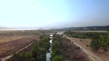 Aerial View Cruising Along The L.A. River In The North Valley Of Los Angeles On A Summer Morning