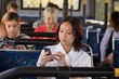 © Wavebreak Media - Female commuter using mobile phone while travelling in modern