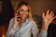 © Nebojsa - Portrait of beautiful blonde woman with glasses waving to friend while talking over a mobile phone
