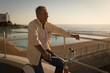 © Wavebreak Media - Senior man sitting on bicycle at promenade