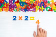 Man's hand doing simple multiplication
