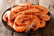 Healthy diet food: boiled wild tiger shrimps close-up on a plate on a table. horizontal