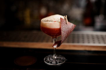 Elegant glass of tasty sweet and fresh orange summer cocktail