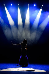 A young woman singer on stage during a concert