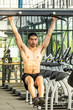 © Golden House Images - Young sport man exercising in fitness gym