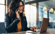 © Jacob Lund - Happy business woman working at the desk