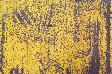 Worn yellow paint on metal sheet texture background