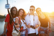 © dusanpetkovic1 - Group of young multicultural beautiful student tourist taking picture of them selves on a summer holiday.