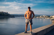 © Dusan Petkovic - Fitness training outdoors. Handsome man working exercises in early morning with sunrise. Muscular man training outside. Sunny fitness morning.