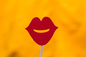 Photo booth props red lips against yellow background