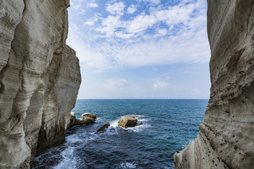 Infinite Mediterranean Sea between two mountain walls and a large stone in the middle