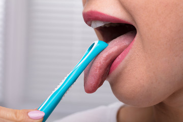 Wall Mural - Woman Cleaning Her Tongue With Cleaner