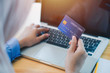 © Rattanasak - Happy woman doing on line shopping at home. portrait of happy woman purchasing product via online shopping. pay using credit card
