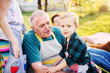 © Dusan Petkovic - Proud grandfather and his grandson are enjoying picnic on a sunny day.