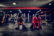 © Dusan Petkovic - Close up of strong focused active couple stretching after training in a gym.