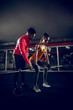 © dusanpetkovic1 - Young fit female is doing dead lifts with a help of her coach.