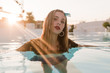 © Angel Ruiz Sanchez - Young blond vintage girl with denim short pants and bandana posing and moving by the water on a pool in a sunset of a sunny day of summer