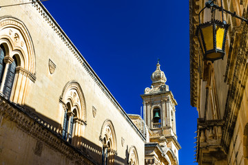 Ancient village of Mdina, Malta in a sunny summer day. View of one of the towers of Mdina.