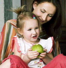 Wall Mural - mother with daughter together in bed smiling, happy family close