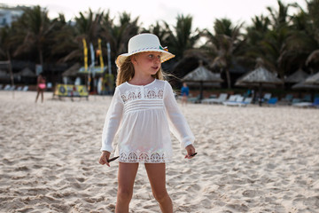 little girl walking on summer tropical beach