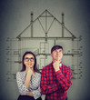 © Feodora - Dreaming couple planning new house sketch