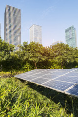 Wall Mural - solar panel with skyscrapers of in blue cloud sky,green city of the future concept