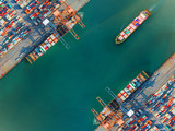 container port terminal keep busy and congestion by the ships vessels are working operation in transfer cantainers cargo shipment, transport and logistics services to global Worldwide