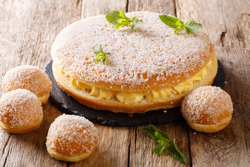 Delicate tropezienne tarte - brioche sandwich cake with cream close-up. Horizontal