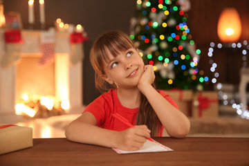 Wall Mural - Little child writing letter to Santa at home. Christmas celebration