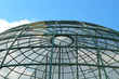Metal large aviary for birds in the form of a dome. Close-up. Background.