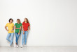 © New Africa - Group of young women in jeans and colorful t-shirts near light wall