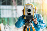 Fototapeta  - engineer site survey with laser tripod machine in site construction background