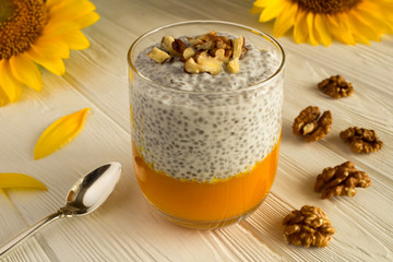 Wall Mural - Pudding with chia,pumpkin  and walnuts  on the white  wooden background