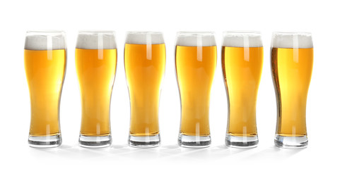 Glasses of beer on white background