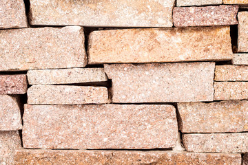 Wall Mural - textured background made of light red stones wall