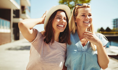 Friends having a fun day walking together in the city