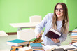 © Elnur - Young female student preparing for exams with many books