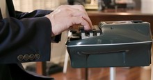 Stenographer Or Court Reporter Typing Out Short Hand Using A Stenograph Or Steno Writer Machine.