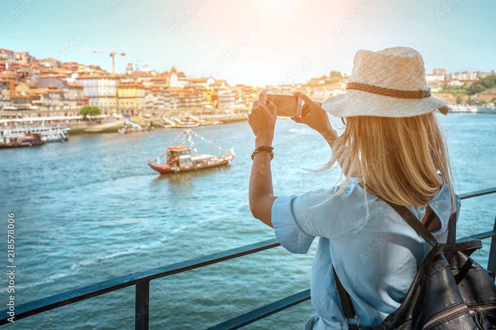 Happy blonde woman - tourist shot on her smartphone camera in Porto Portugal - obrazy, fototapety, plakaty 