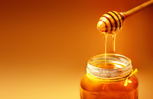 Honey In Jar With Honey Dipper On Rustic Wooden Table Background. Copy Space.