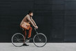© oneinchpunch - Handsome young business man with his modern bicycle.