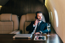 Businessman Flying On His Private Jet. Business Man Flying On The Private Airplane. Working During The Flight To His Meeting. Concept About Transportations And Salespeople	
